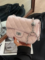 Elegant quilted crossbody bag with chain strap and spacious design

