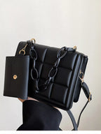 Back view of black quilted chain strap crossbody bag