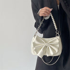 Pearl Chain Bow Underarm Bag styled with outfit on model