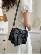 Black quilted crossbody bag side view with chain strap